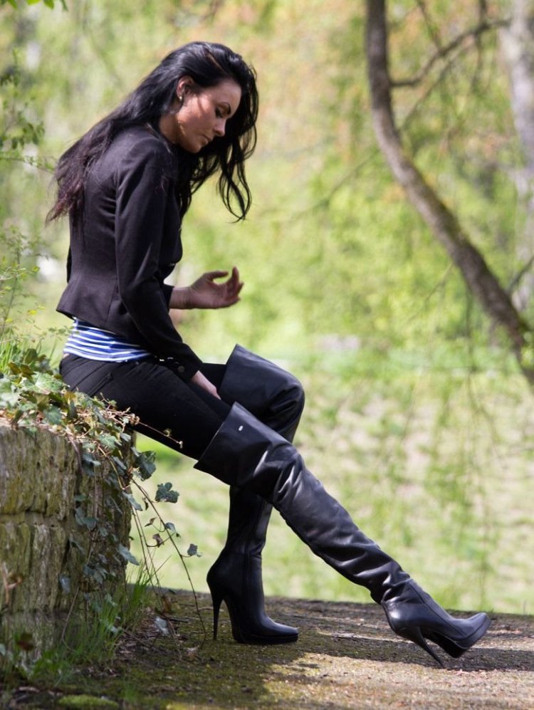 Женщина в болотных сапогах в глубокой воде