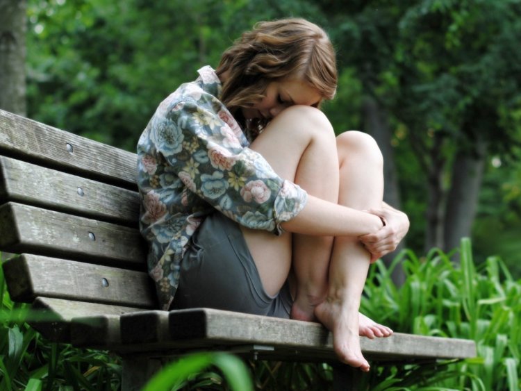 Девушка сидит на лавочке