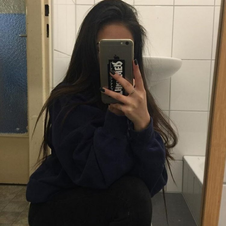 Девочка с коричневыми волосами с айфоном