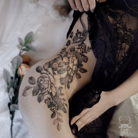 Женская татуировка на бедре