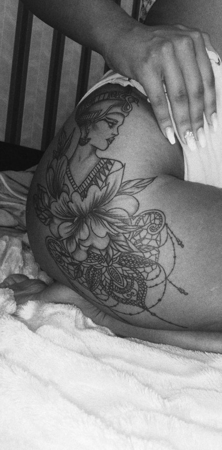 Женская татуировка на бедре