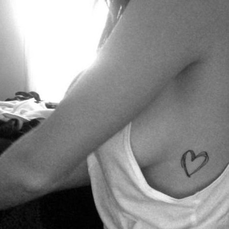 Татуировка под сердцем у девушки