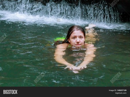 Девушка плавает в реке