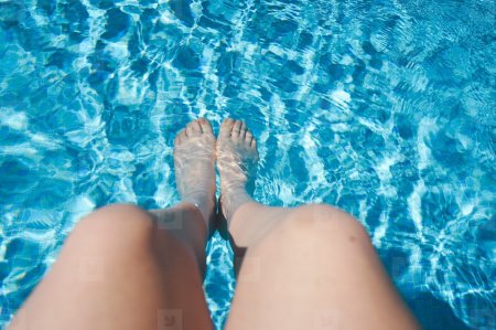 Девочка в маленьком бассейне мокрые ножки